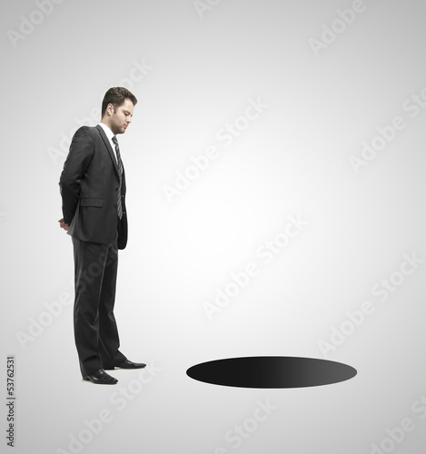 Photo: man looking at hole man looking at hole