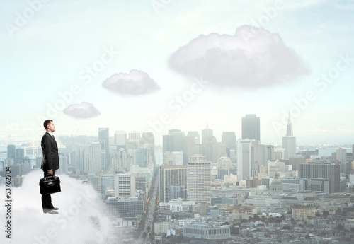Photo: businessman standing on cloud businessman standing on cloud
