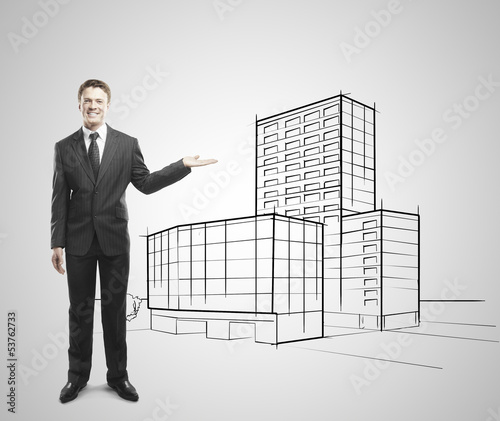 Photo: businessman showing skyscraper businessman showing skyscraper