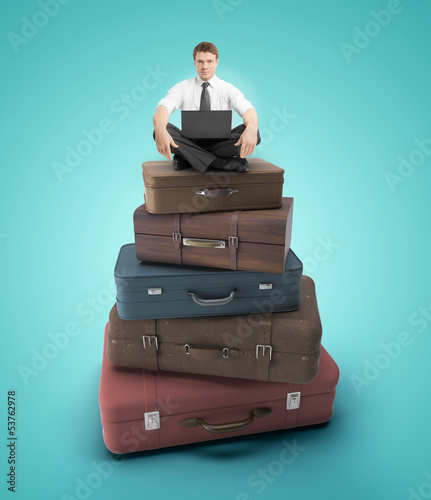 Photo: man sitting on bags man sitting on bags