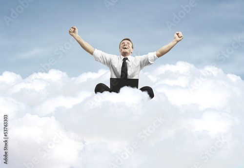 Photo: success of man sitting on a cloud success of man sitting on a cloud