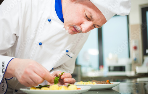Photo: Chef garnishing a dish Chef garnishing a dish
