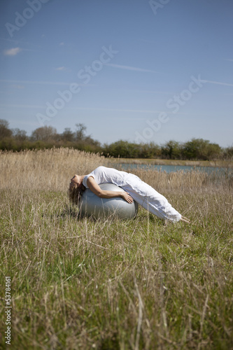 Photo: A mature woman stretching on an exercise ball A mature woman stretching on an exercise ball
