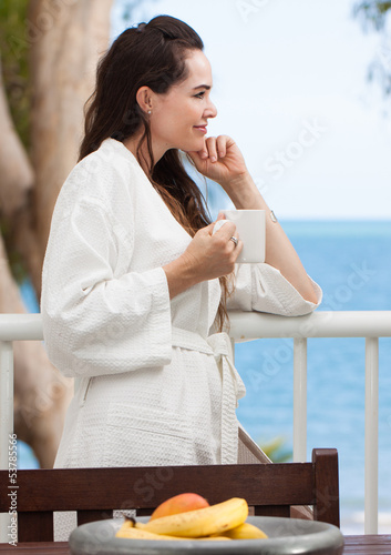 Photo: Woman relaxing with breakfast coffee Woman relaxing with breakfast coffee