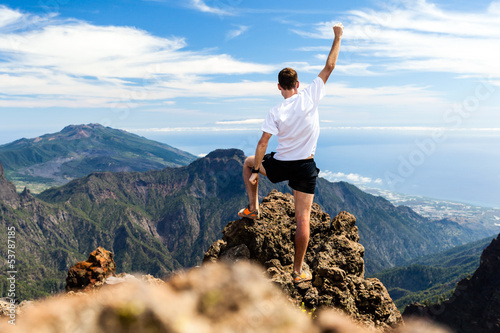 Photo: Trail runner success, man running in mountains Trail runner success, man running in mountains