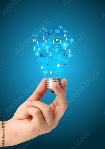 Photo: Light bulb in hand with technology business network Light bulb in hand with technology business network