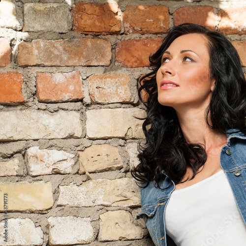Photo: Beautiful young woman at the bricks Beautiful young woman at the bricks