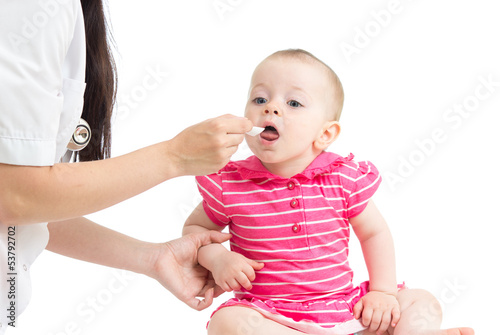 Photo: doctor giving drug to child girl isolated on white doctor giving drug to child girl isolated on white