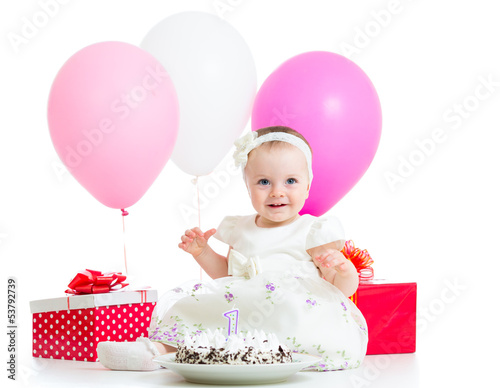 Photo: Joyful baby girl with cake, balloons and gifts. Isolated on whit Joyful baby girl with cake, balloons and gifts. Isolated on whit