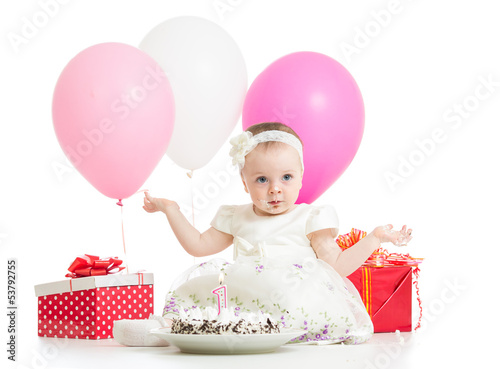 Photo: Joyful baby girl with cake, balloons and gifts. Isolated on whit Joyful baby girl with cake, balloons and gifts. Isolated on whit