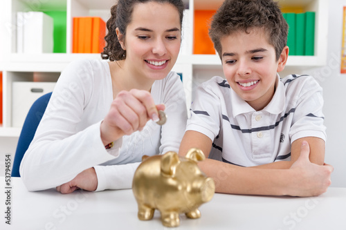 Photo: siblings with piggybank siblings with piggybank