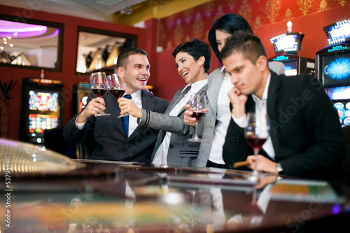 Photo: Two couple gambling in casino Two couple gambling in casino