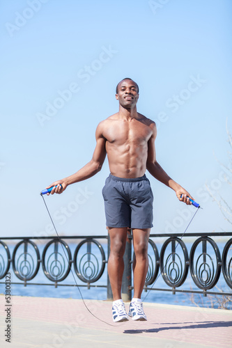 Photo: Trainings everyday. Young african decsent men jumping on the rop Trainings everyday. Young african decsent men jumping on the rop