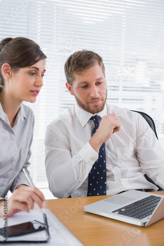 Photo: Businessman meeting with a colleague using laptop Businessman meeting with a colleague using laptop