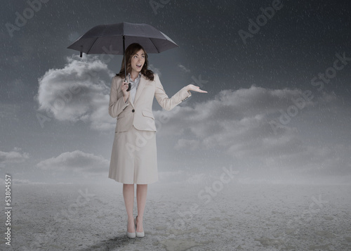 Photo: Businesswoman holding an umbrella Businesswoman holding an umbrella