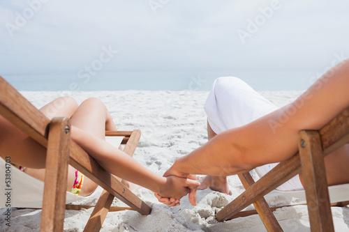 Photo: Couple resting on deck chairs Couple resting on deck chairs