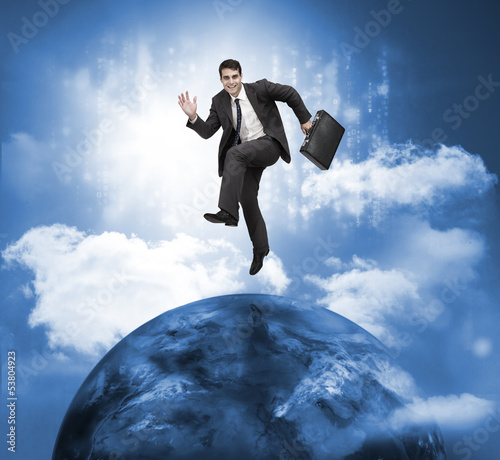 Photo: Businessman jumping over a planet Businessman jumping over a planet