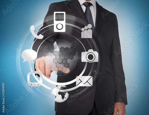 Photo: Businessman selecting icons on a hologram Businessman selecting icons on a hologram