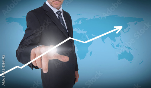 Photo: Businessman selecting an arrow pointing up Businessman selecting an arrow pointing up