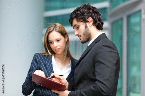 Photo: Couple of young businesspeople at work Couple of young businesspeople at work