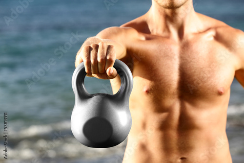 Photo: Crossfit fitness man training with kettlebell Crossfit fitness man training with kettlebell