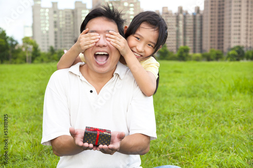 Photo: surprised father holding gift box from little girl for father's surprised father holding gift box from little girl for father's
