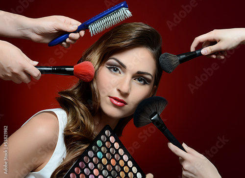 Photo: The beautiful girl with brushes make-up The beautiful girl with brushes make-up