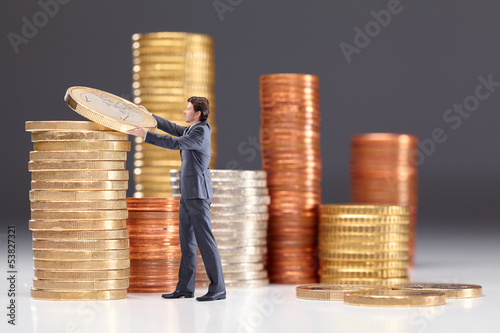 Photo: Business man saving money Business man saving money