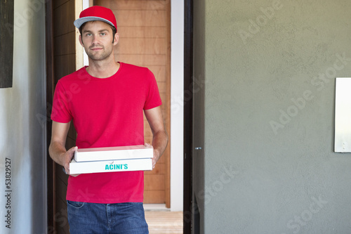 Photo: Portrait of a deliveryman delivering pizza Portrait of a deliveryman delivering pizza