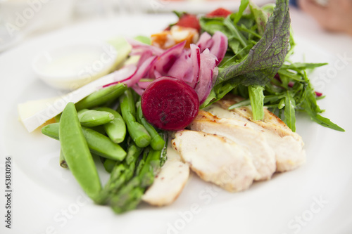 Photo: Close-up of green salad with asparagus, beans, onion slices and other vegetables Close-up of green salad with asparagus, beans, onion slices and other vegetables