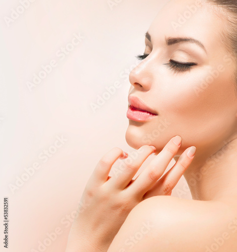 Photo: Spa Girl. Beautiful Young Woman Touching Her Face Spa Girl. Beautiful Young Woman Touching Her Face