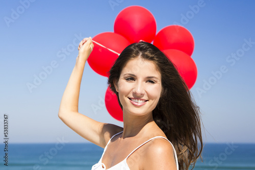 Photo: Beautiful girl holding red ballons Beautiful girl holding red ballons