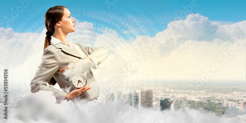 Photo: Businesswoman holding alarmclock Businesswoman holding alarmclock