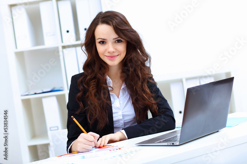 Photo: Young busines woman with notebook Young busines woman with notebook