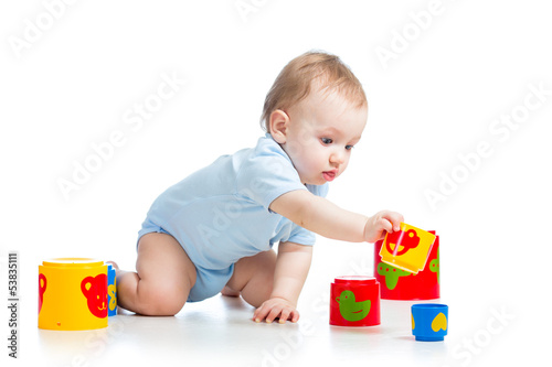 Photo: baby boy playing with toys, isolated over white baby boy playing with toys, isolated over white