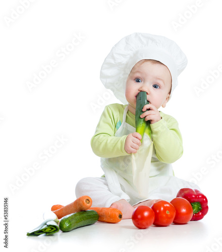 Photo: baby boy wearing a chef hat with healthy food vegetables baby boy wearing a chef hat with healthy food vegetables