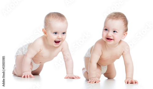 Photo: Smiling babies girl and boy crawling on floor Smiling babies girl and boy crawling on floor