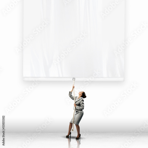 Photo: Businesswoman pulling banner Businesswoman pulling banner