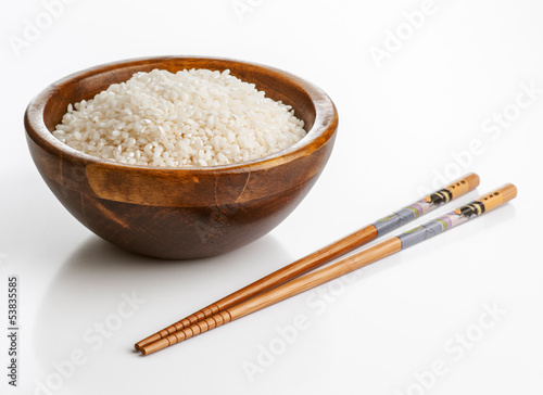 Photo: Wooden bowl with rice and Chinese chopsticks Wooden bowl with rice and Chinese chopsticks