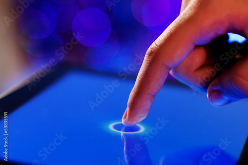 Photo: Finger touching screen Finger touching screen