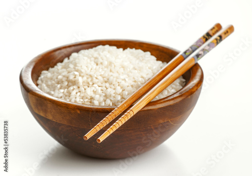 Photo: Wooden bowl with rice and Chinese chopsticks Wooden bowl with rice and Chinese chopsticks