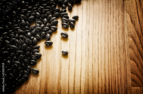 Photo: Black beans on wooden background Black beans on wooden background