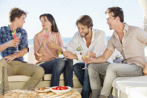 Photo: Group of friends enjoying drinks outdoors on vacation Group of friends enjoying drinks outdoors on vacation
