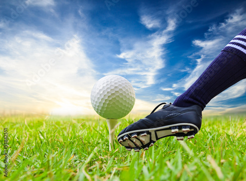 Photo: foot kicking golf ball on tee foot kicking golf ball on tee