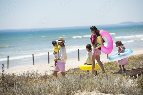 Photo: Family walking on a boardwalk on the beach Family walking on a boardwalk on the beach