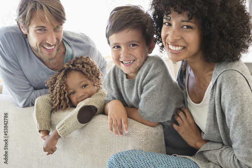 Photo: Portrait of a couple smiling with their children Portrait of a couple smiling with their children