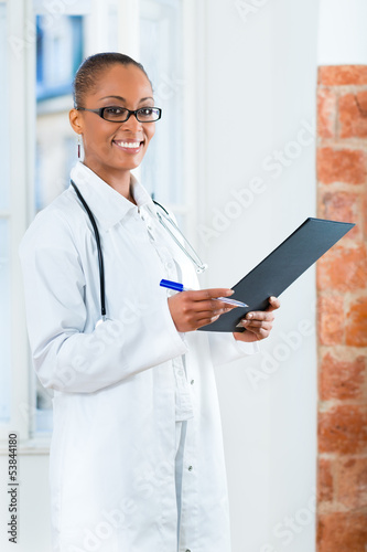 Photo: Portrait of young female doctor in clinic Portrait of young female doctor in clinic