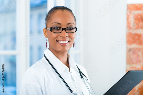 Photo: Portrait of young female doctor in clinic Portrait of young female doctor in clinic