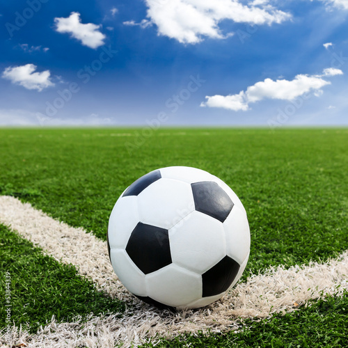Photo: football on green grass field conner football on green grass field conner