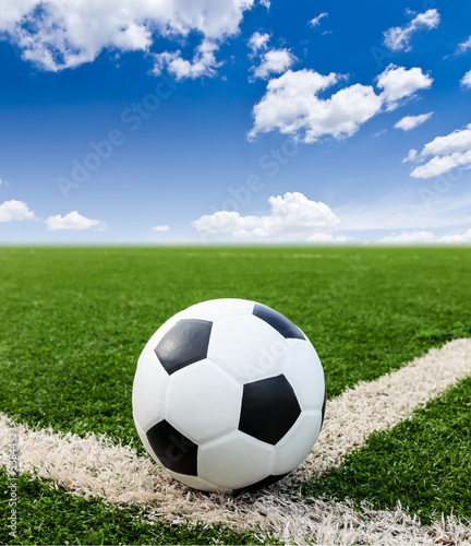 Photo: football on green grass field conner football on green grass field conner